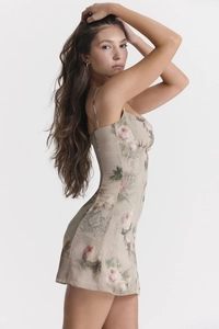 Detail of slim-fit floral mini dress featuring pink rose patterns and pleated neckline