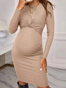 Close-up of oatmeal ribbed knit maternity dress with twist knot detail and long sleeves