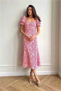 Detail of pink floral dress featuring retro square neck and stylish puff sleeves
