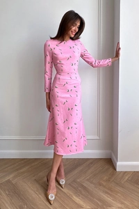 Detail of light pink floral midi dress with green prints and elegant cinched waistline