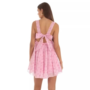 Pink floral mini dress with large bow back design and ruffled A-line hem on white background