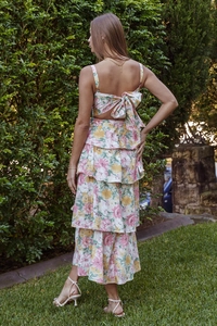 Detail of floral dress showing back cutout, large bow tie and tiered ruffles on the skirt