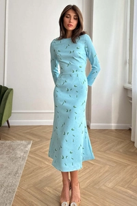 Detail of light blue floral dress with cinched waist and delicate print pattern