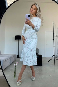 Mirror selfie showing the detail of a white floral long-sleeved midi dress with high waist