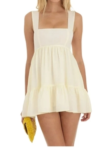 Detail of square neckline and high-waist pleated ivory summer dress with ruffled hemline