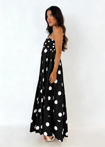 Detailed close-up of a black and white polka dot maxi dress with thin shoulder straps