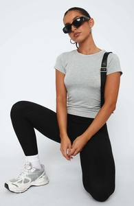 Detail of slim fit grey short sleeve tee paired with high waist black leggings for yoga