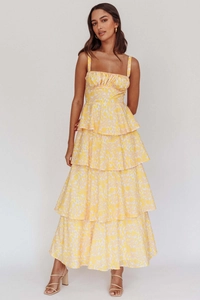 Detail of a yellow floral tiered maxi dress with thin straps and ruffled chest design