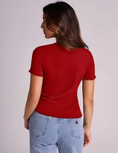 Detail of red ribbed knit top featuring delicate lettuce edge sleeves and neckline