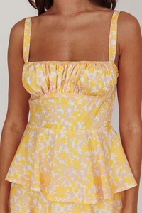Detail of the yellow floral pattern and pleated bust design on this summer camisole dress