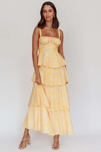 Detail of yellow floral maxi dress featuring a tiered skirt and pleated bodice design