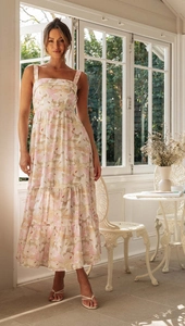 Detailed view of square neck floral maxi dress with tiered skirt in soft summer lighting