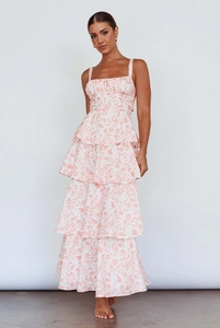 Detail of a white floral tiered maxi dress with coral flower prints and a square neckline