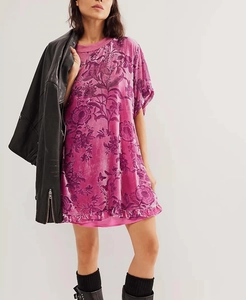 Detail of floral print velvet dress with ruffle hem and vintage purple flower pattern