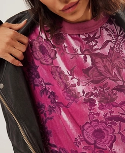 Close-up of floral velvet dress with ribbed neckline styled under a black jacket