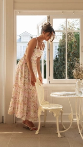 Detail of light floral strap dress with backless design and layered cake skirt texture