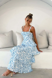 Detail of blue floral tiered maxi dress featuring high waist and spaghetti straps