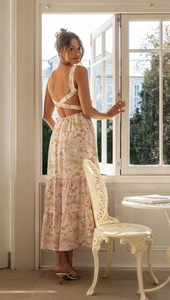 Detail of floral maxi dress featuring a cross-back lace-up design and tiered skirt layers