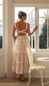 Detailed back view of a summer floral dress with lace-up cutout design and layered skirt