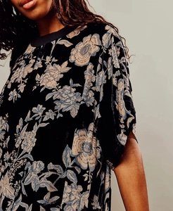Close-up of vintage floral print on premium black velvet short sleeve mini dress