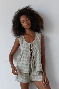 Detail view of plaid two-piece set featuring front tie-up sleeveless top and matching shorts