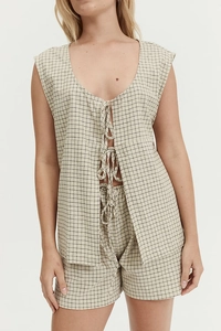 Detailed view of women's summer two-piece set featuring lace-up top and checkered shorts