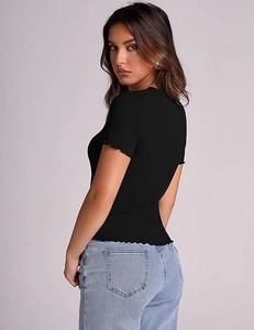 Detail view of black ribbed t-shirt showing the lettuce trim edge on sleeves and hemline