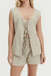 Detail of checkered vest and shorts set showing tie-front closures and breathable fabric