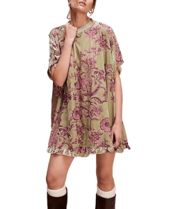 Detailed close-up of vintage green velvet floral mini dress with ruffled hem and round neck