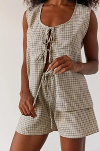 Detail of plaid cotton linen set featuring sleeveless tie-front top and matching shorts