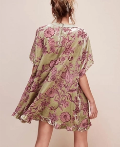 Detail of vintage velvet mini dress with floral print and back zipper closure