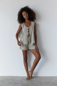 Detailed close-up of green and white gingham summer set with lace-up top and high waist shorts