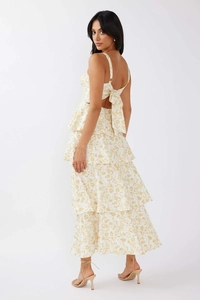 Detail showing the large back bow and layered floral ruffled skirt of the white dress