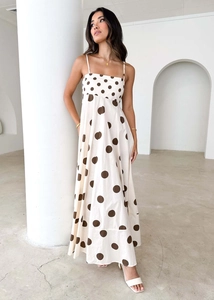 Close-up of beige polka dot maxi dress featuring high-waist cut and linen texture