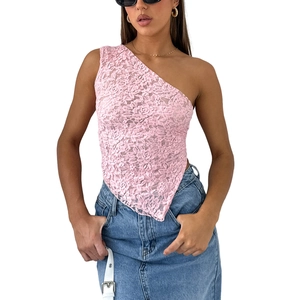 Detail of pink lace asymmetric crop top showing intricate floral hollow textures and fabric