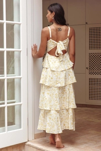 Detail of floral backless dress showing delicate bow tie and tiered ruffles