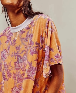 Close-up of vintage orange velvet floral dress texture and grey ribbed crew neckline