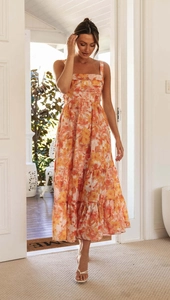 Close-up of the floral tiered dress featuring a square neck and ruffled hemline