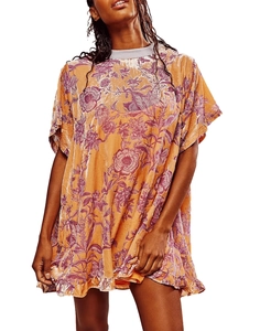 Detail of vintage velvet mini dress featuring orange floral print and soft ruffled hemline