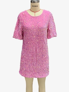 Detail of pink sequins on a short-sleeve velvet dress with shiny texture and round neck
