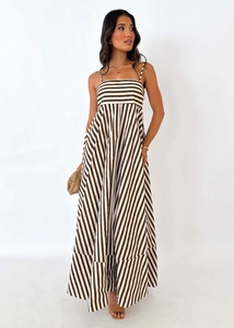 Detailed view of striped A-line maxi dress with slim straps and draped fabric texture