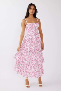 Detail of multi-layered floral maxi dress with pink blossoms on white fabric