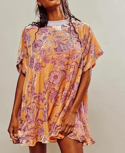 Close-up of velvet pleated fabric with vintage floral print and ribbed crew neckline