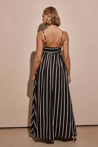 Detail view of the open back design on a striped maxi dress with elegant pleats