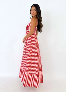 Detailed view of red and white striped maxi dress with multi-directional fabric pattern