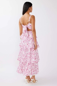 Detail of floral maxi dress featuring elegant back bow tie and tiered ruffled skirt layers