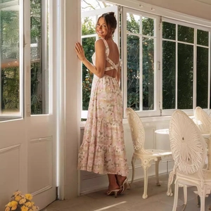 Elegant backless floral maxi dress with cross straps and tiered skirt for summer vacation