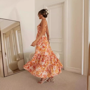 Elegant backless floral maxi dress with tiered ruffle skirt in orange and beige floral print