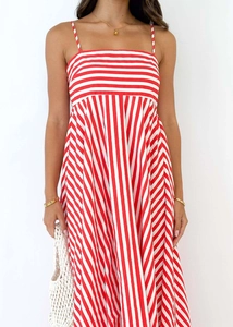 Front view of a red and white striped maxi dress with thin straps and a flared high waist hem