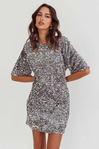 Close-up of sparkling silver sequins on the elegant velvet mini dress fabric texture